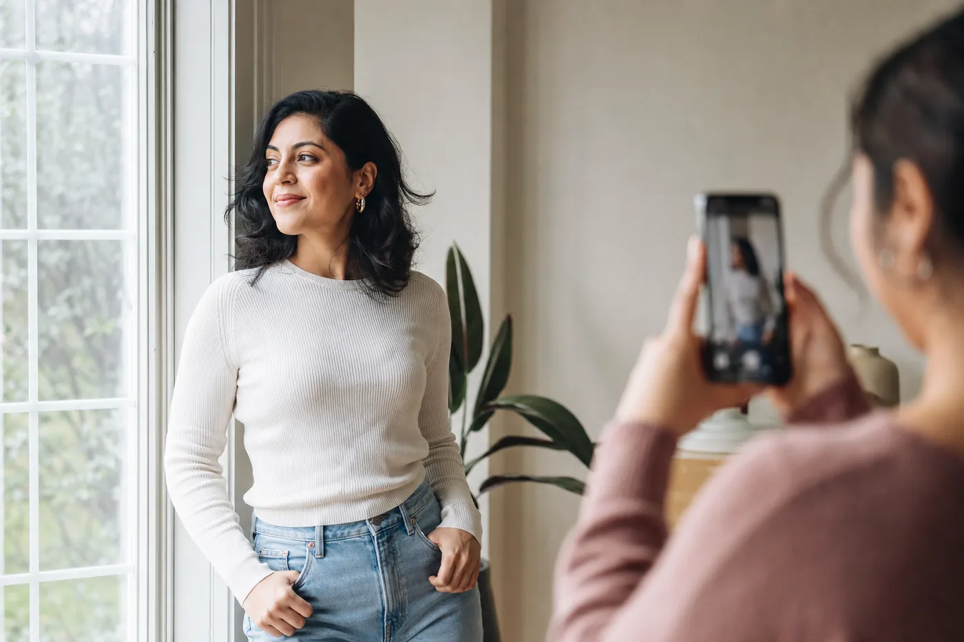 Person using soft window light while a friend takes a natural portrait